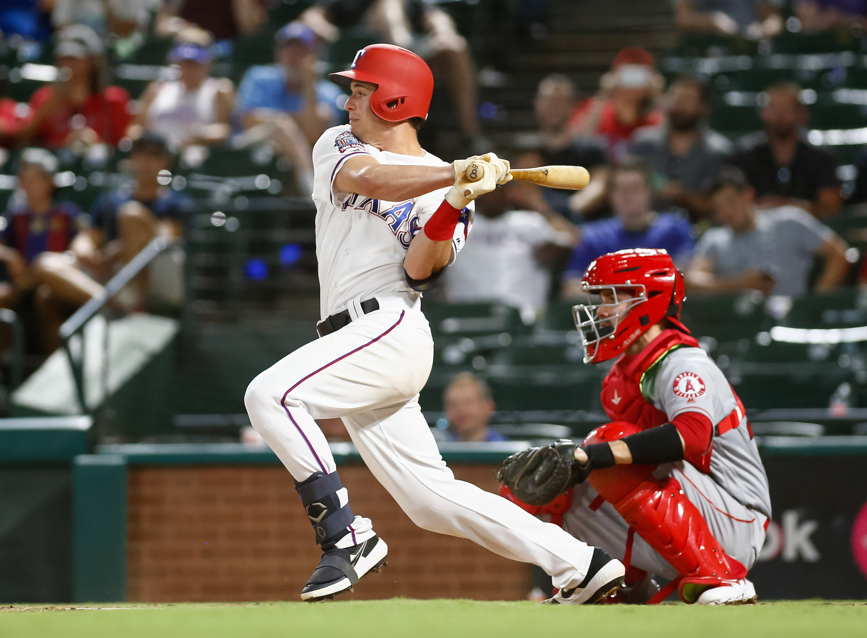 Rookies push Rangers to 3-2 win for split of DH with Angels