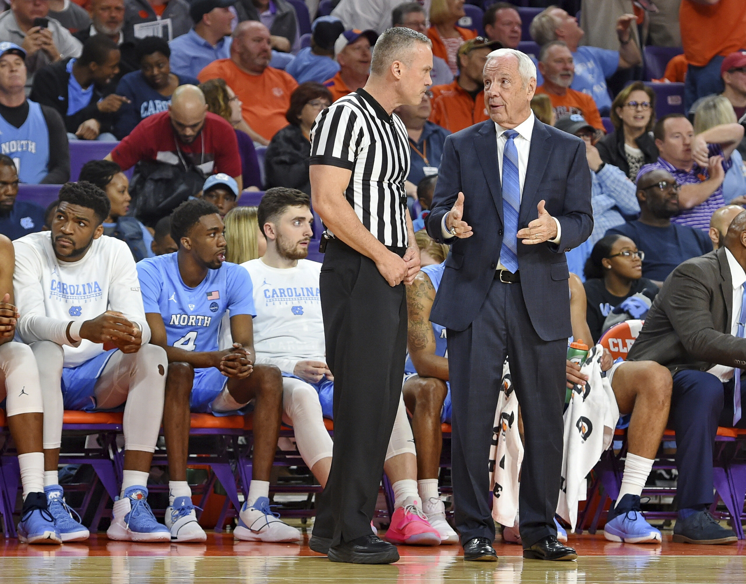 UNC's Roy Williams falls near bench, helped off court