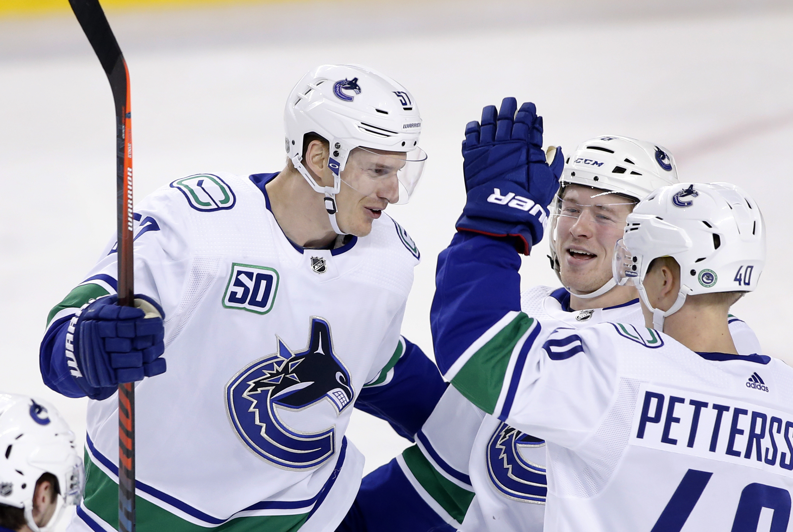 Myers has 2 goals, assist to help Canucks beat Flames 5-2