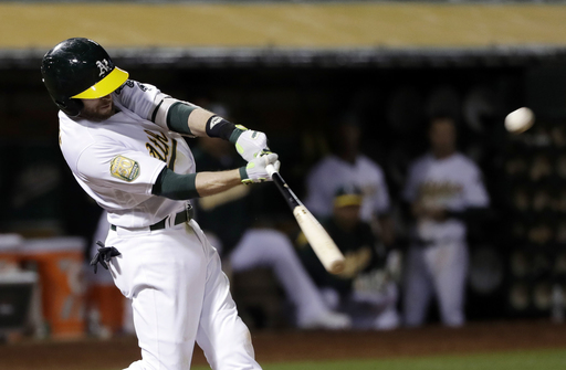 Lowrie’s two-run double in 7th lifts A’s past Rangers 3-1