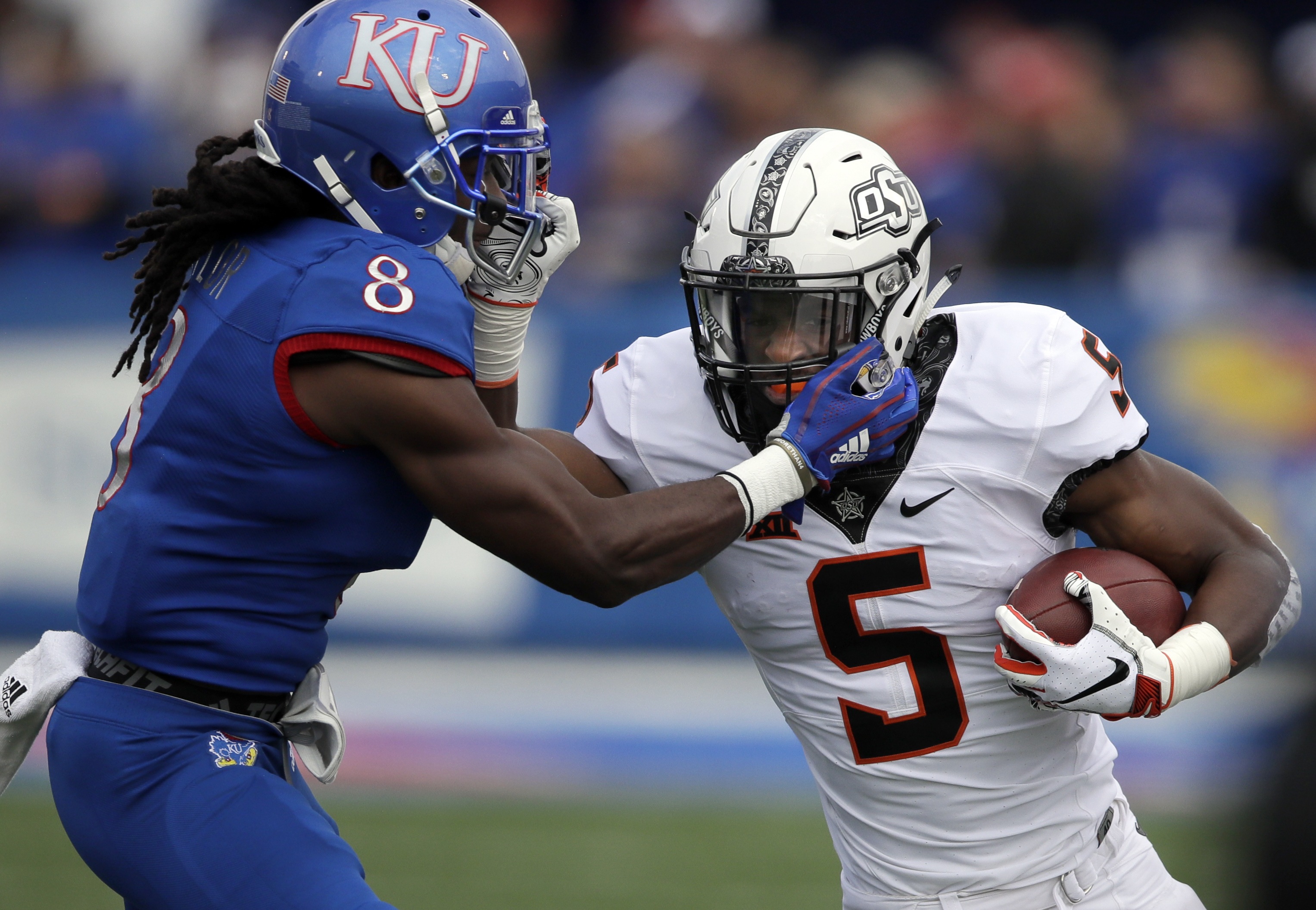 Cornelius tosses 4 TDs, leads Oklahoma St past Kansas 48-28