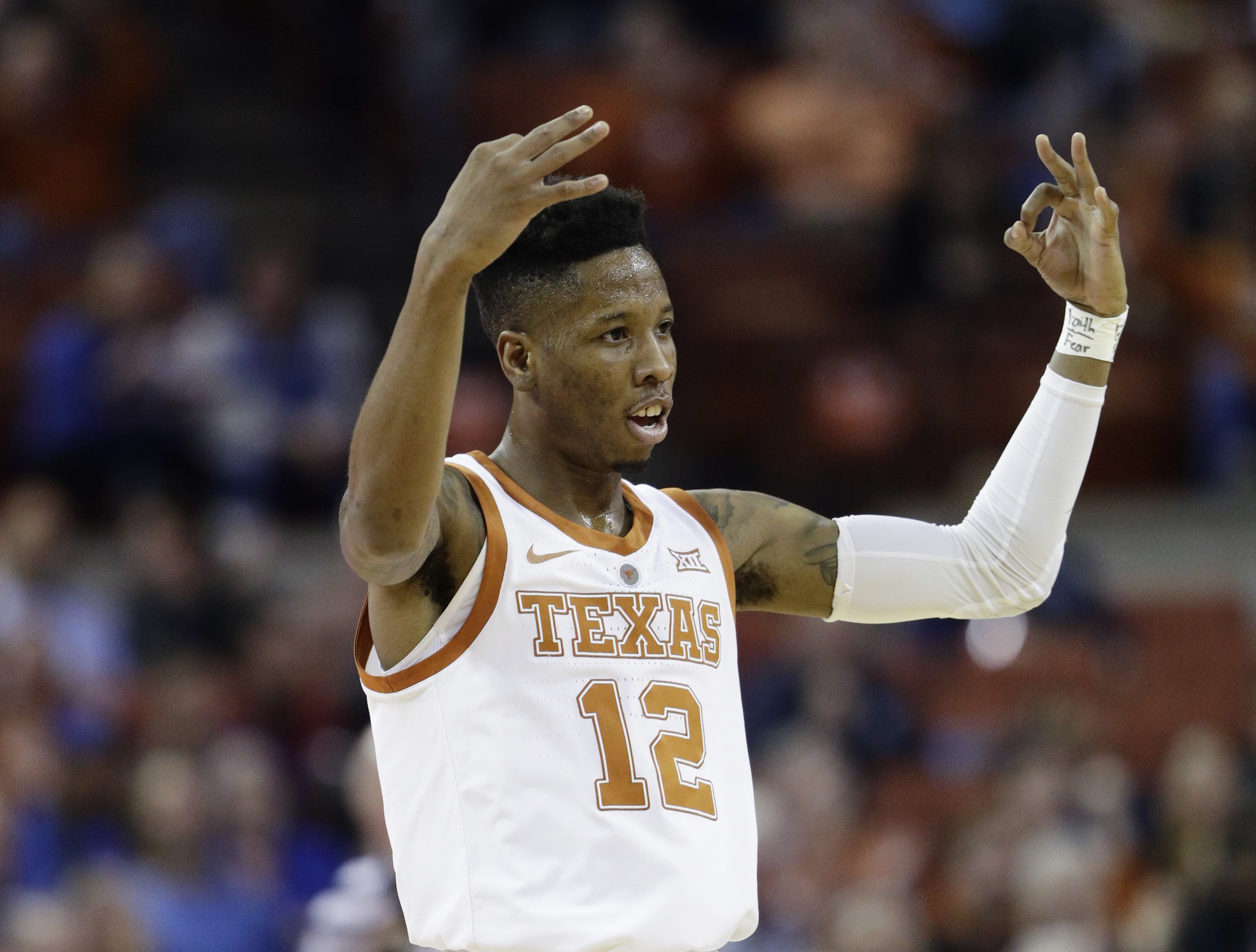 Osetkowski, defense lead Texas past No. 11 Kansas 73-63