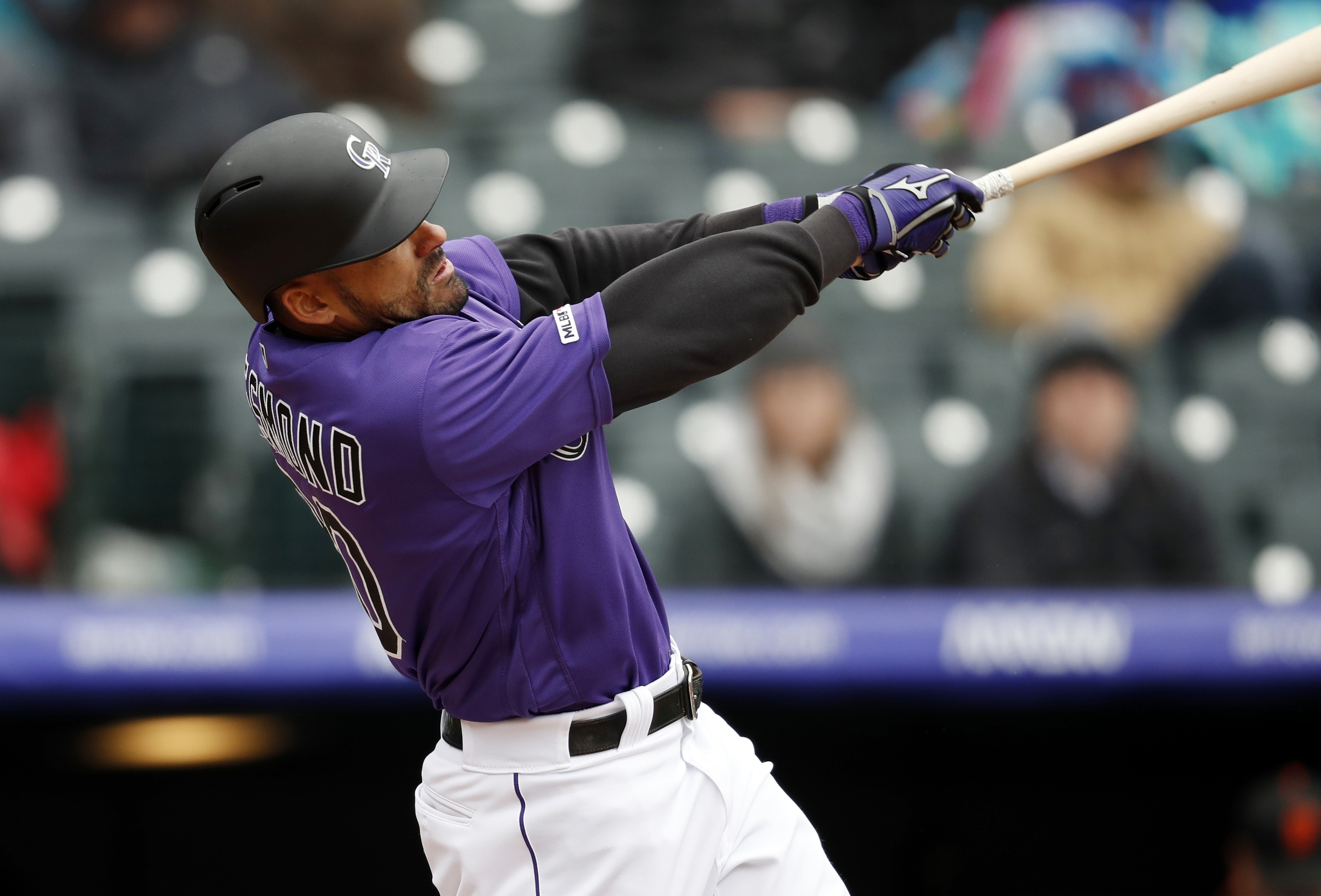 Rockies rally to beat Giants 12-11 at wintry Coors Field