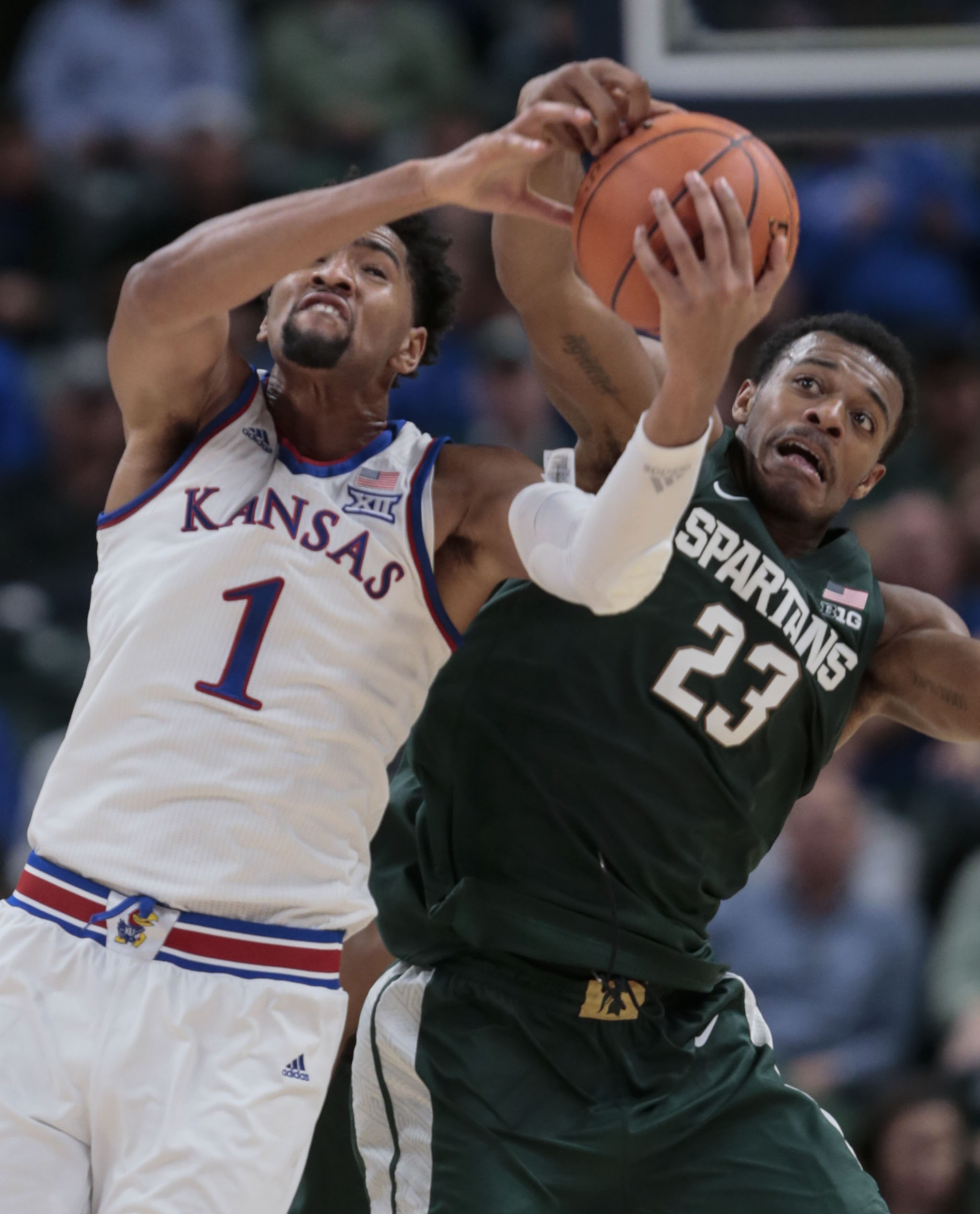 No. 1 Kansas holds off No. 10 Michigan State 92-87 in opener