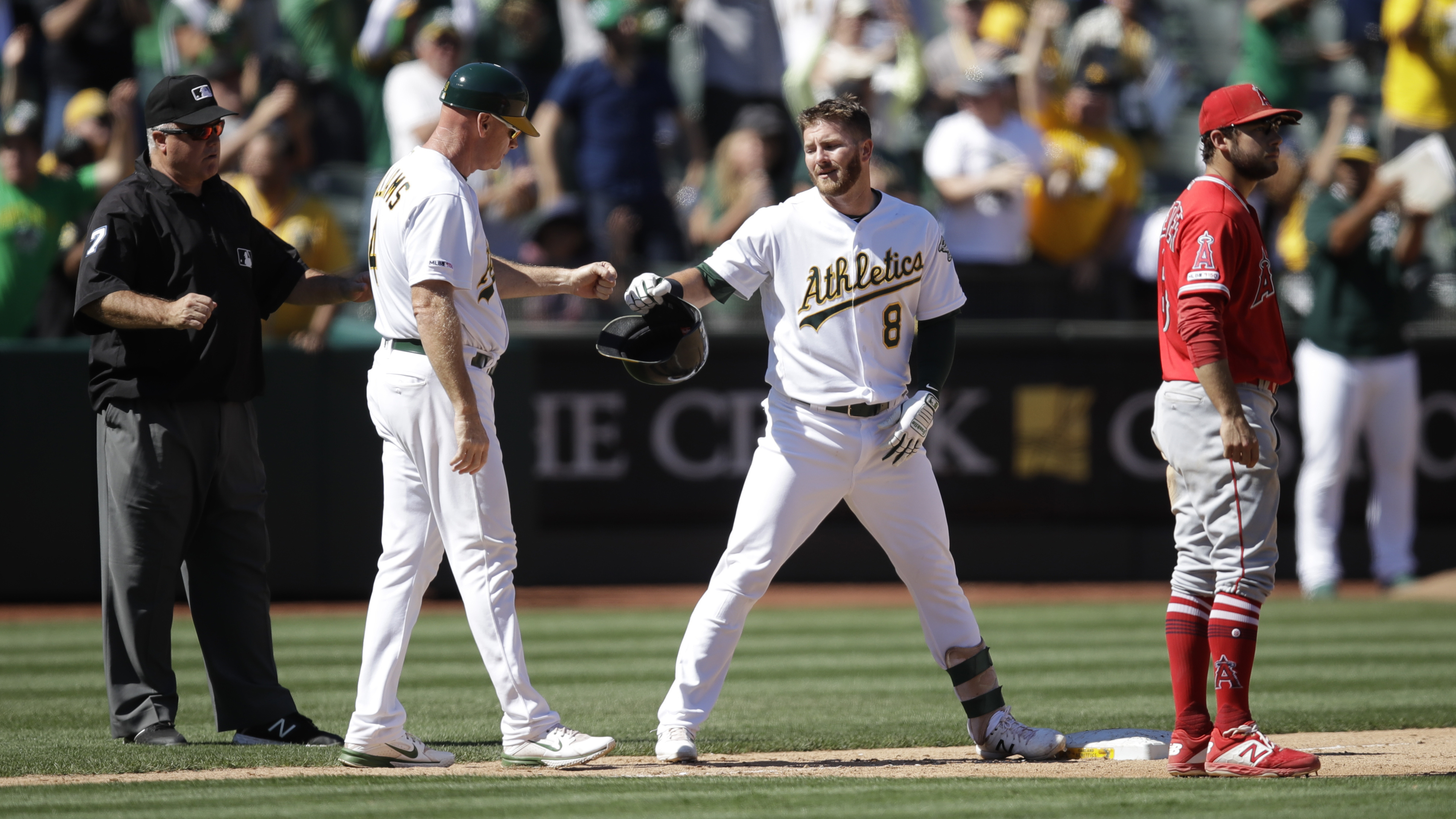A's score 7 in 7th to beat Angels 10-6; Trout hits 45th