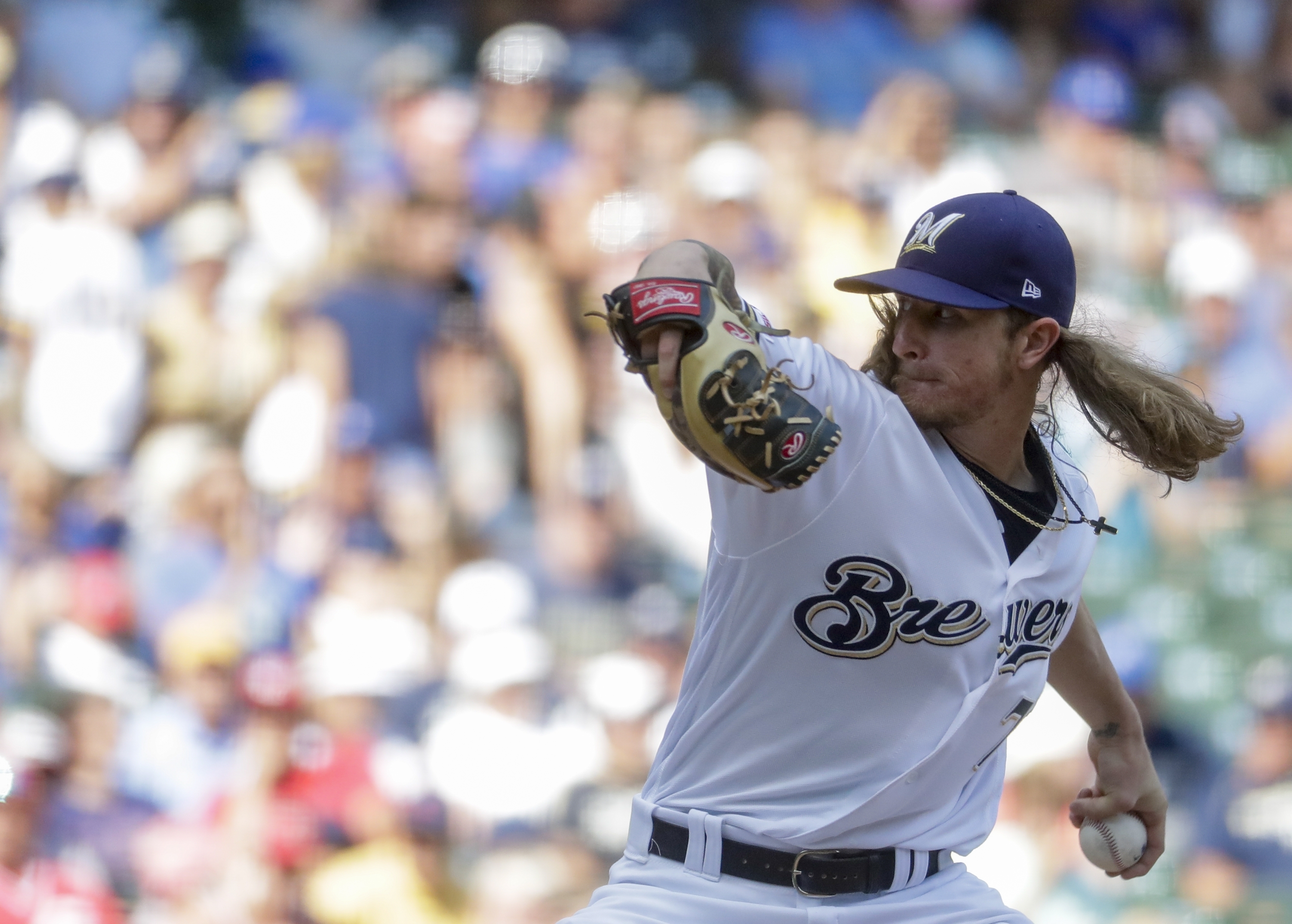 Grandal, Hader lift Brewers over Reds 5-4 to avoid sweep