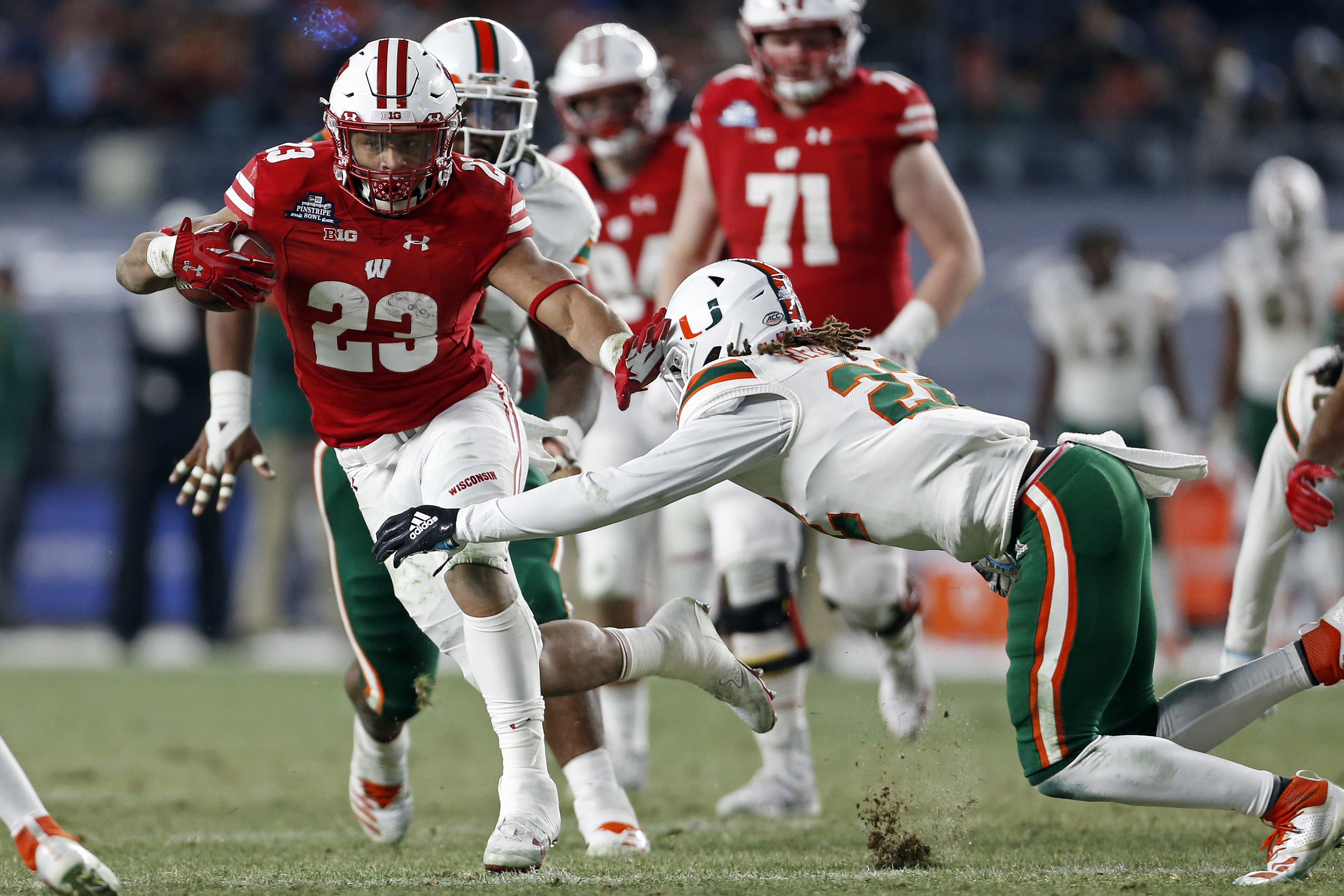 Taylor runs for 205 yards in Wisconsin’s Pinstripe victory