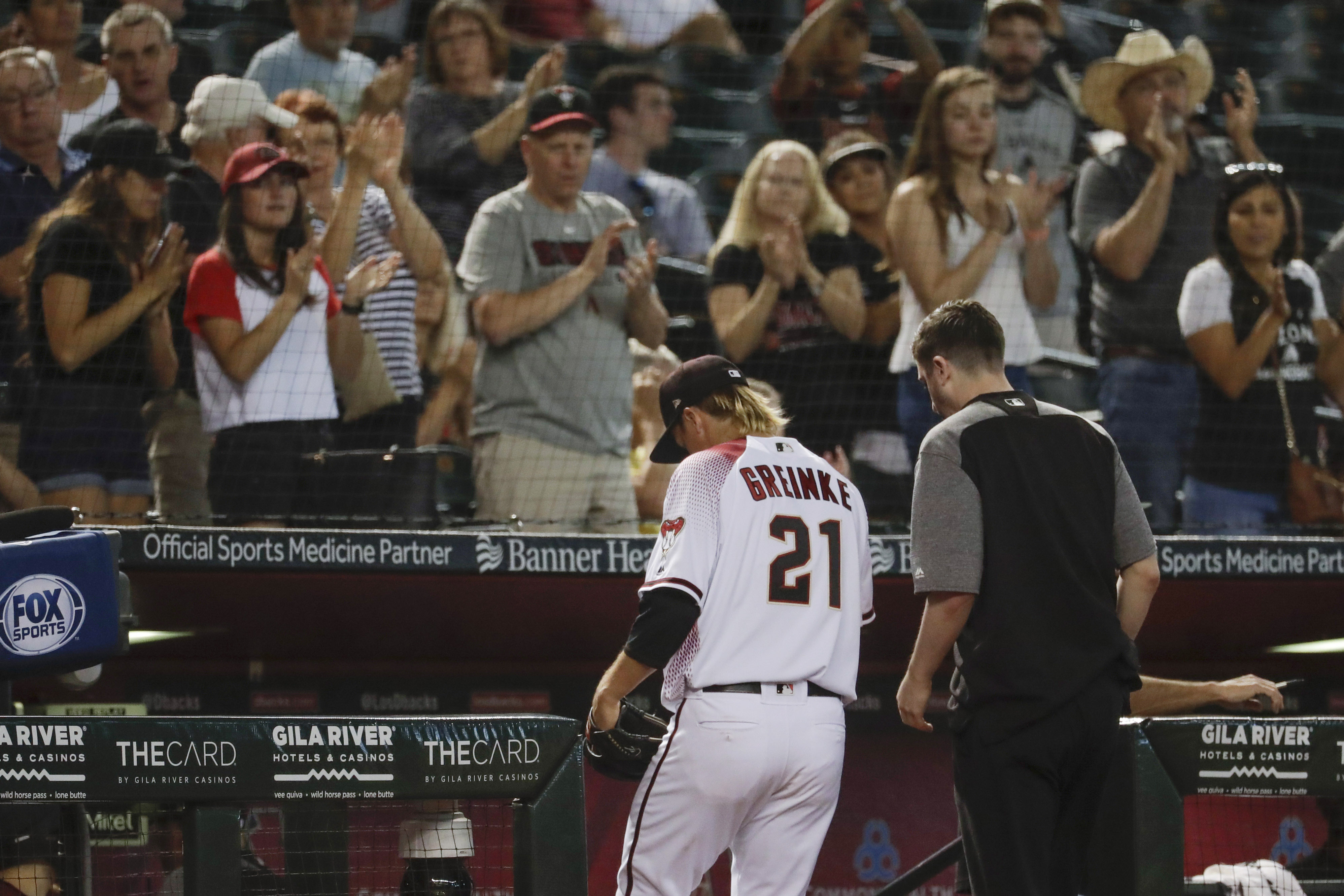 Greinke stars, then exits with trainer, D-backs rout Pirates