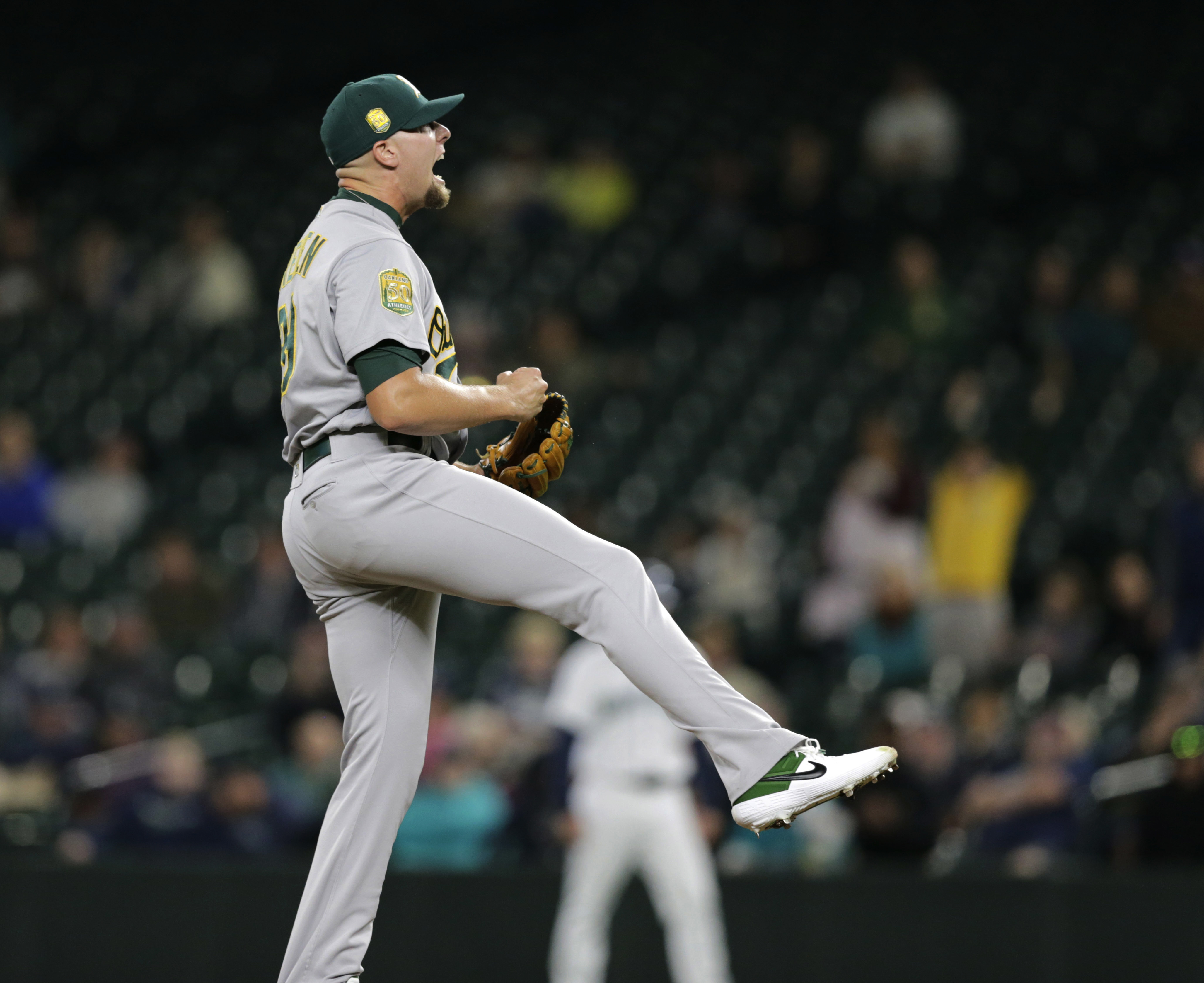 A’s clinch playoff berth, then beat Mariners 7-3